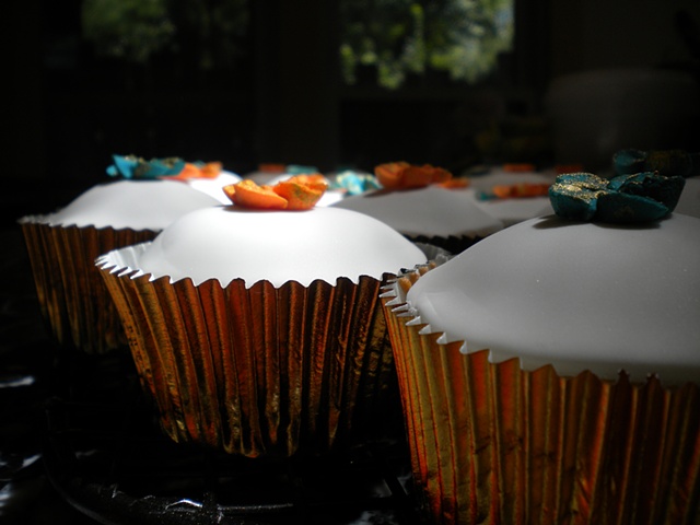 Cupcakes finished with fondant, hand made flowers and edible gold flake.